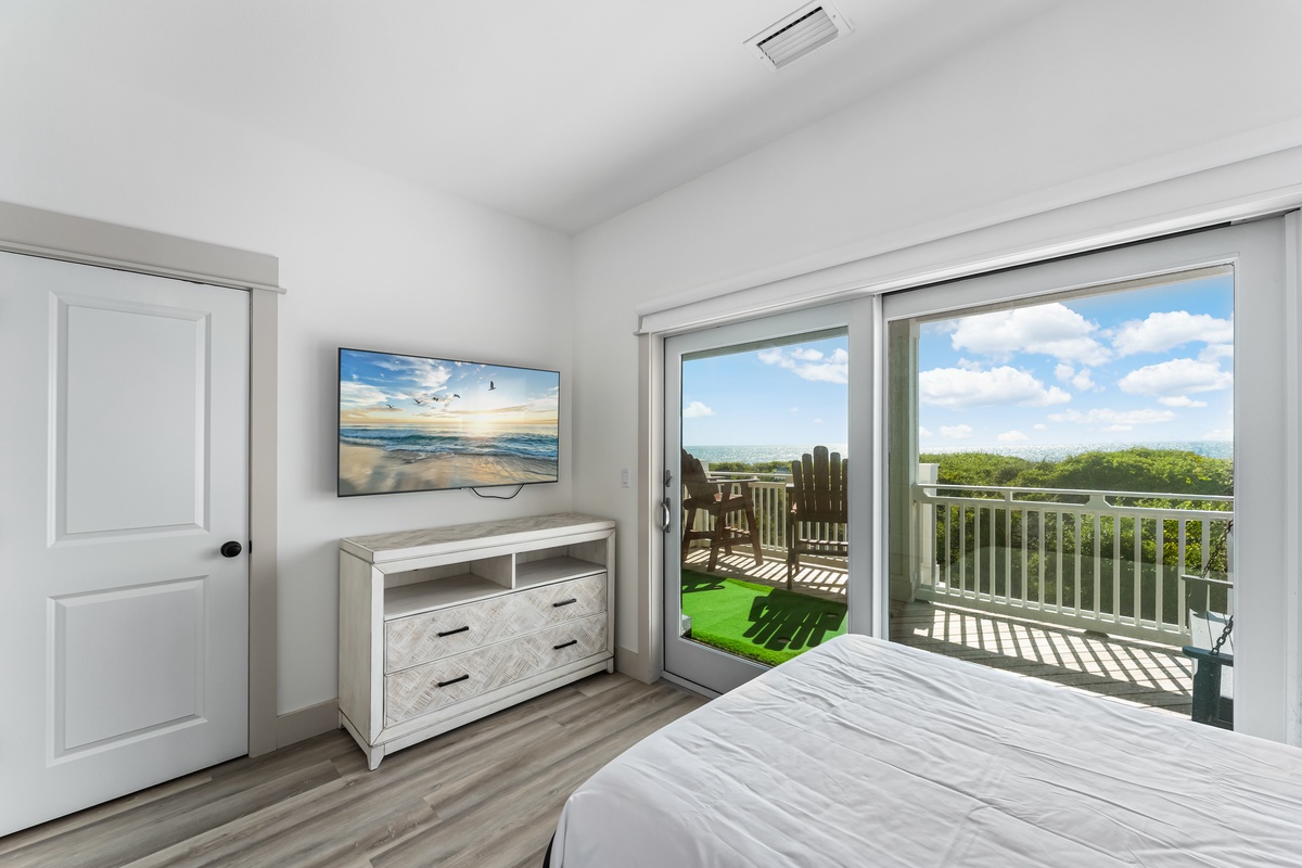 Wake up to breathtaking views from your bright bedroom, where sliding doors open to your private balcony overlooking lush greenery.