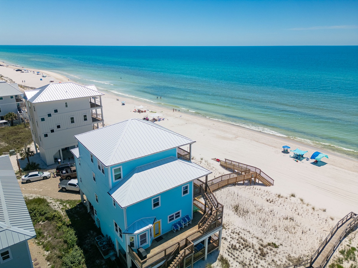 The vibrant beachfront property sits just steps from pristine white sand and turquoise waters, offering direct beach access for your seaside escape.