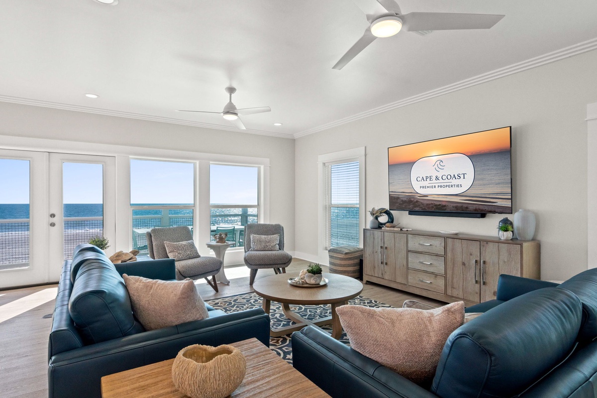 Sink into plush blue leather sofas while ocean waves dance outside your floor-to-ceiling windows in this elegantly appointed living space.