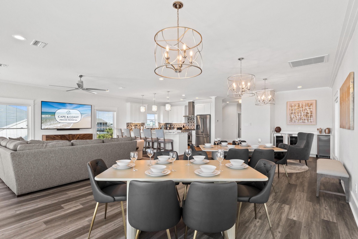 Your open-concept space flows seamlessly, blending dining, living, and kitchen areas under stunning statement lighting—perfect for gathering and making memories together.