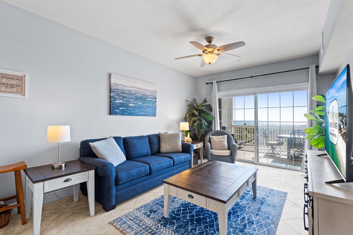 Unwind in your coastal living room where ocean breezes flow through sliding doors to your private balcony with stunning views.
