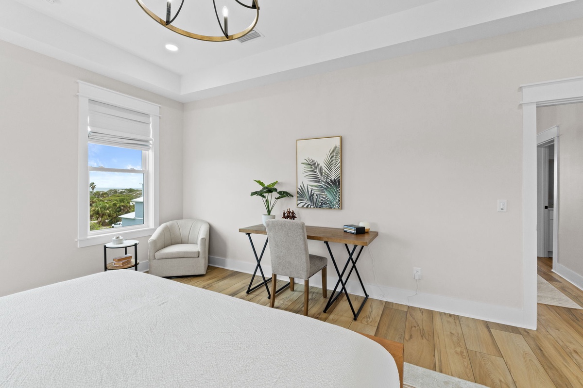 Your bright bedroom offers a cozy reading chair and work nook with tropical views, plus wood floors and calming decor that make unwinding effortless.