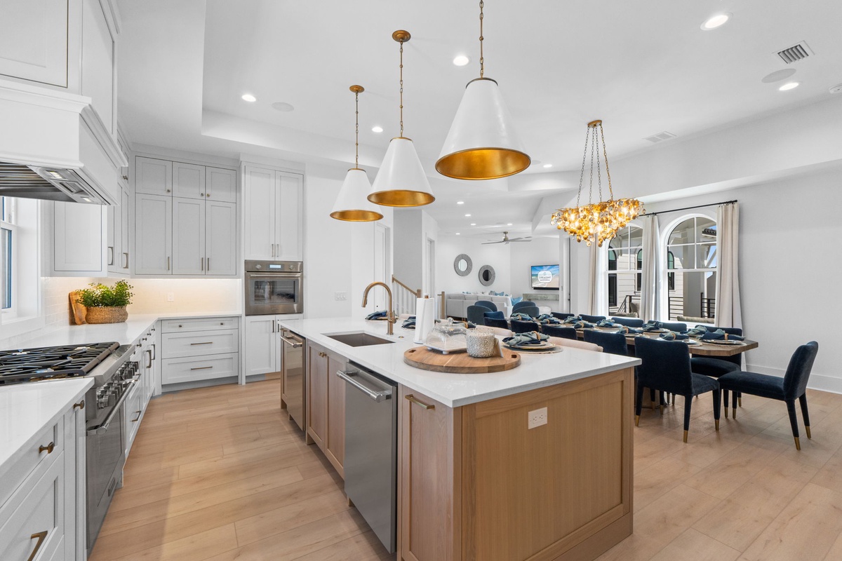 Cook together in this stunning gourmet kitchen featuring gleaming quartz countertops, professional appliances, and elegant pendant lighting that flows into your dining space.