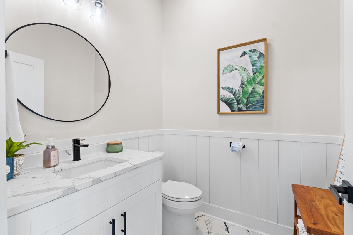 Refresh in this bright, modern bathroom with stylish tropical accents, sleek fixtures, and a spacious vanity perfect for your morning routine.