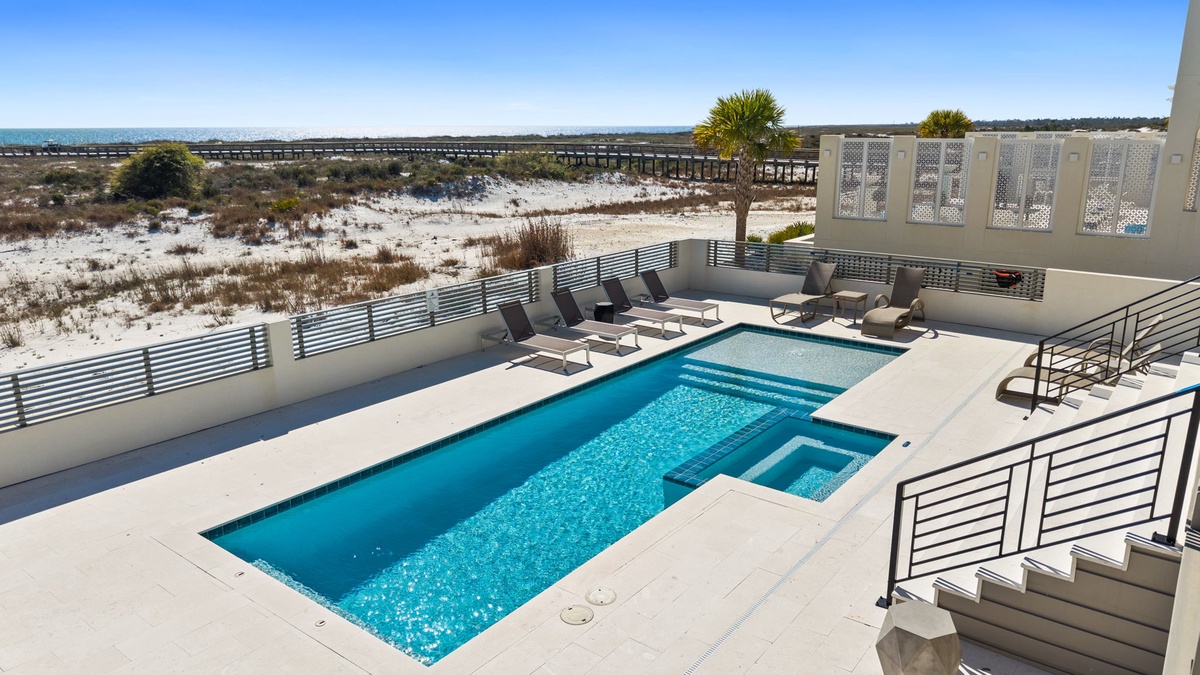 Your private pool deck overlooks pristine dunes and coastline, perfect for morning swims and sunset lounging.