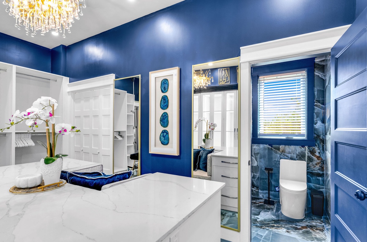 Your private bathroom oasis features stunning blue walls, elegant marble touches, and luxurious details that transform your daily routine into pure indulgence.