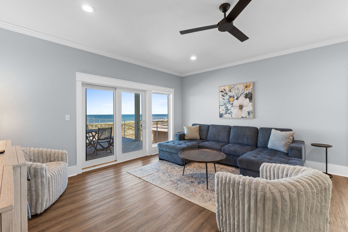 Unwind in your inviting living room where ocean breezes and stunning coastal views create the perfect backdrop for relaxation and memorable moments with loved ones.