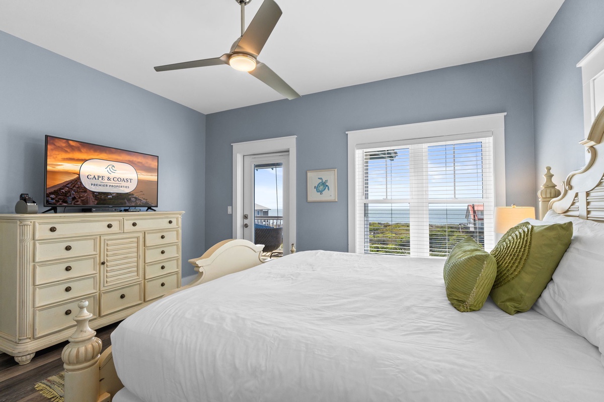 Wake up to serene blue walls and crisp white linens in your coastal retreat, where ocean views await just outside your window.