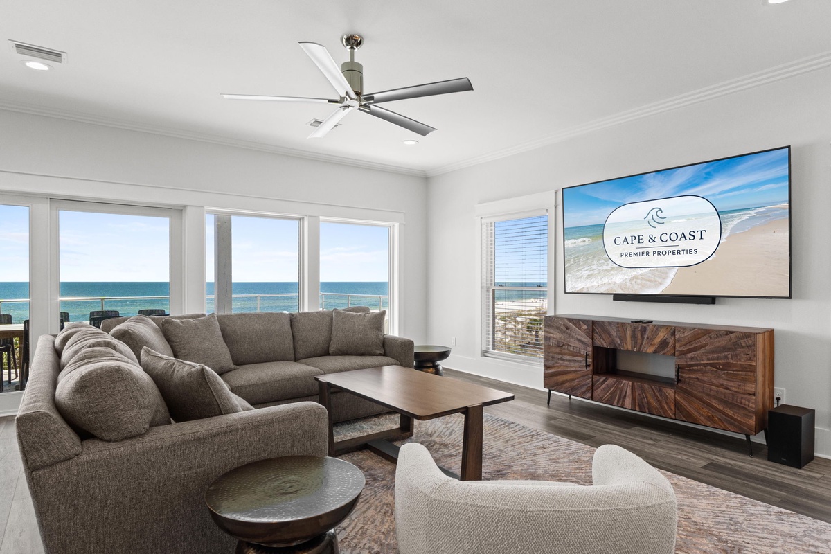 Unwind in your elegant living room with sweeping ocean views, plush seating, and modern comforts—your perfect coastal retreat awaits.