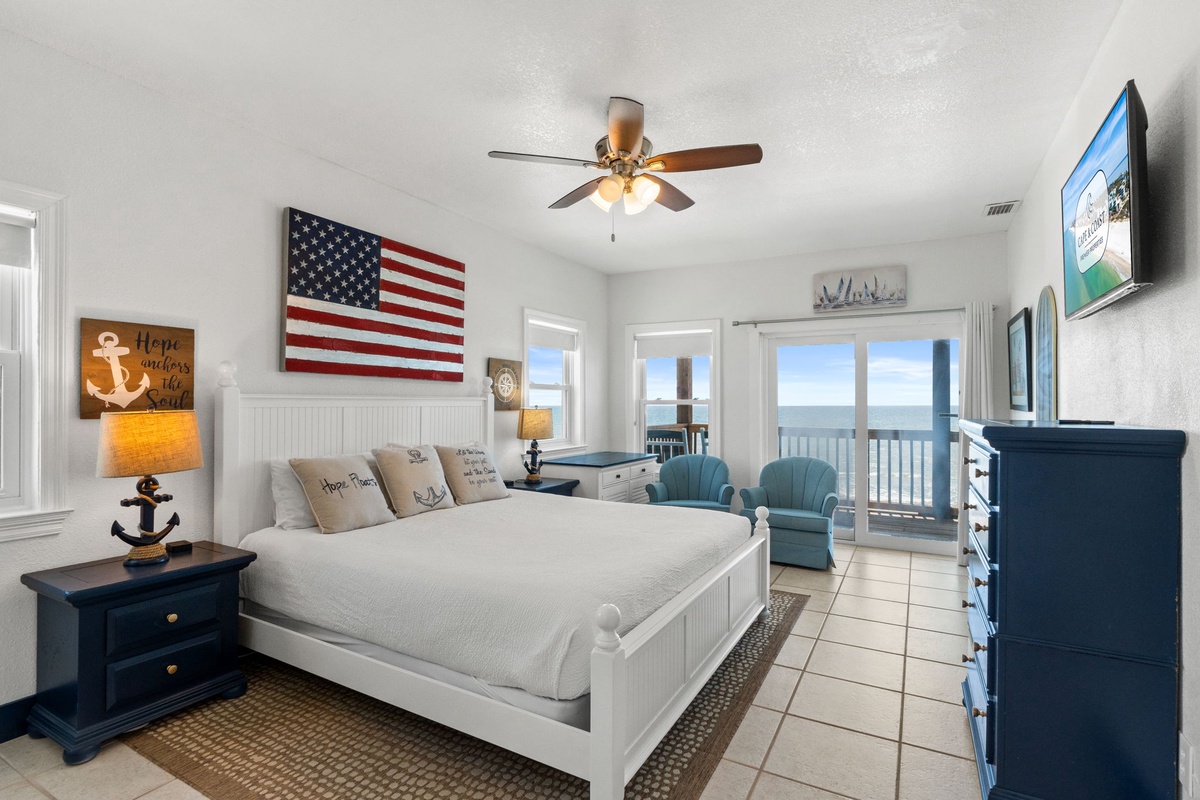 Your coastal retreat features a queen bed dressed in crisp linens, nautical touches throughout, and direct balcony access to breathtaking ocean views—perfect for morning coffee by the sea.