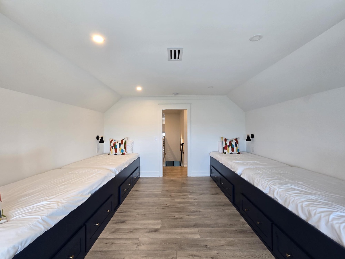 Your spacious bedroom features two comfortable beds with built-in storage, perfect for sharing with friends or family members.