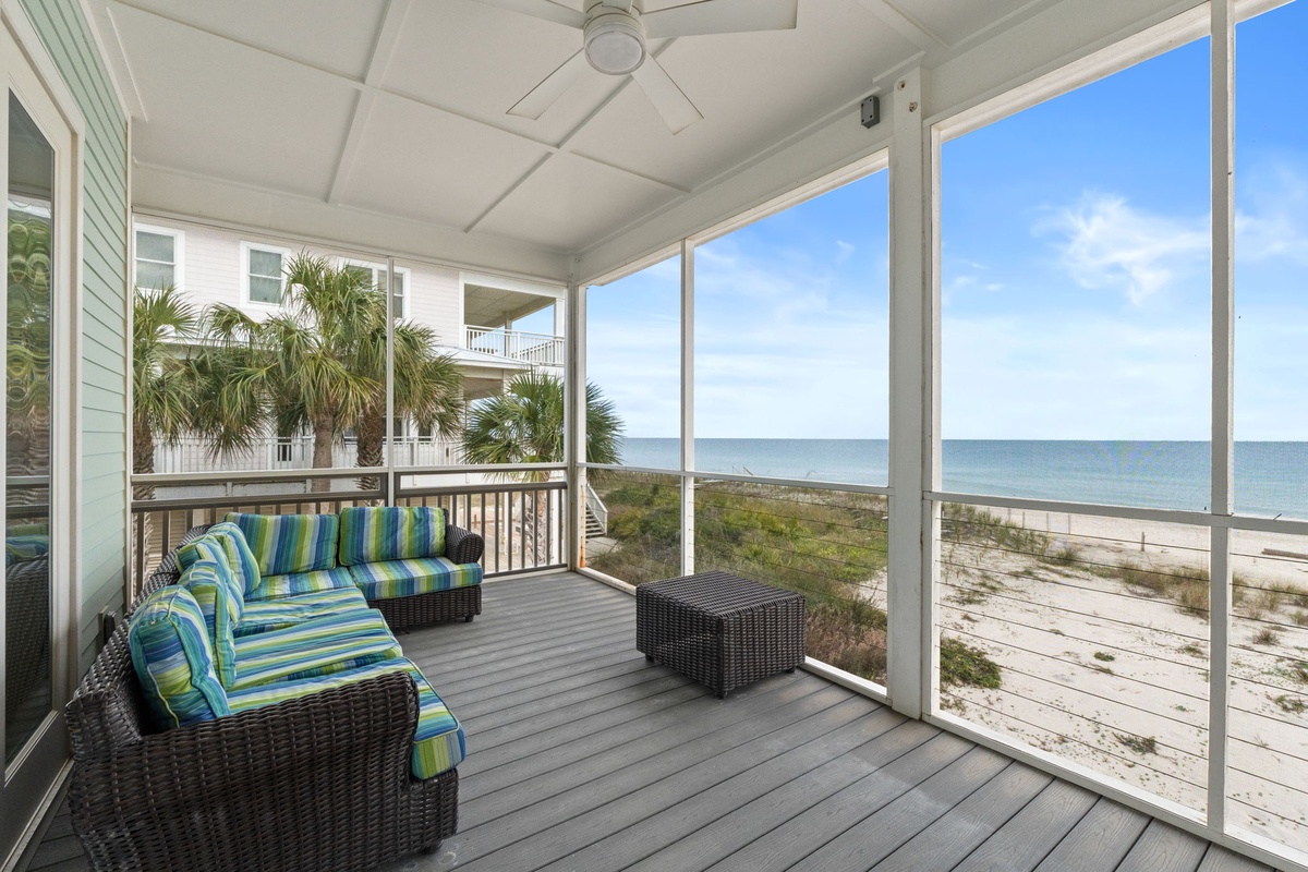 Relax on your private screened porch with stunning ocean views, where comfortable seating and coastal breezes create the perfect beachside retreat.