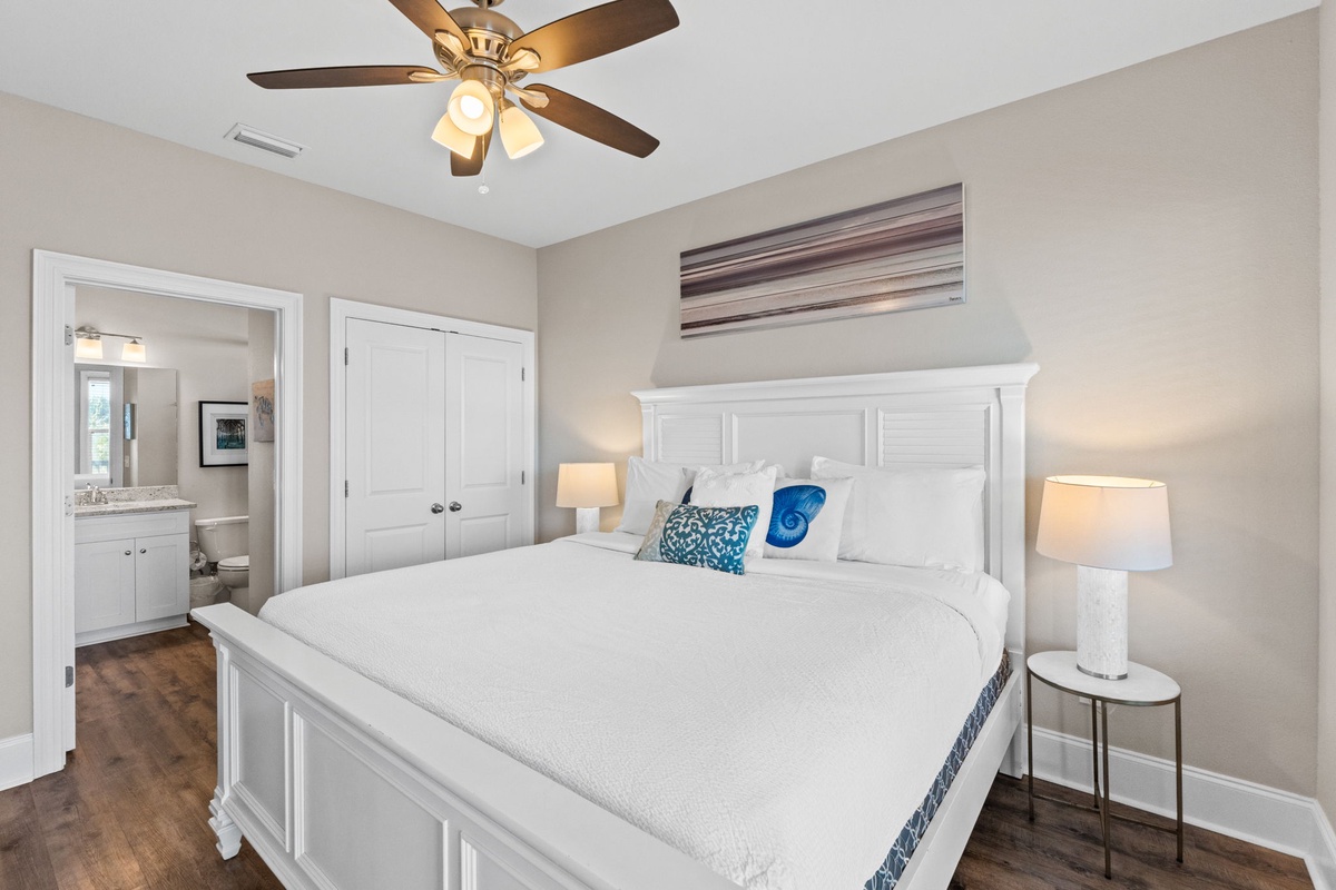 Your peaceful bedroom sanctuary features a plush king bed, soothing coastal touches, and gentle ceiling fan for ultimate comfort.