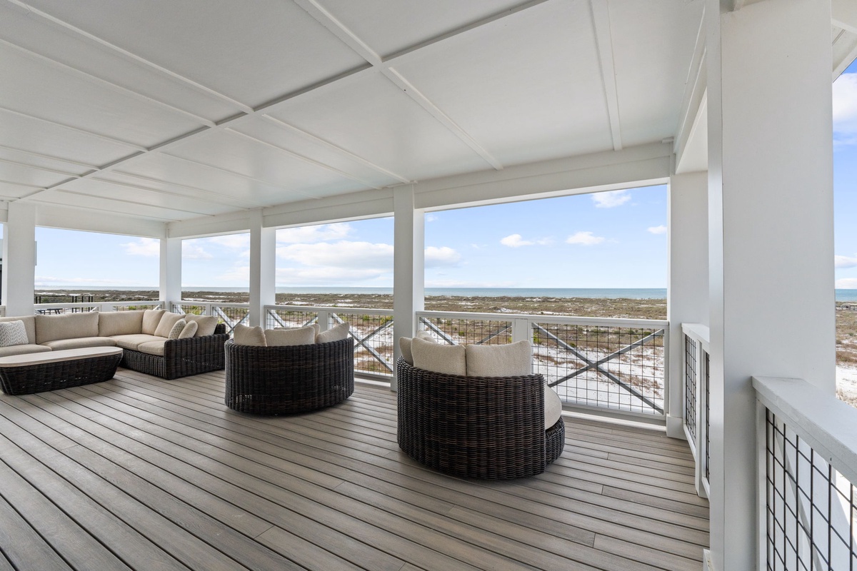 Relax in your private covered terrace with sweeping coastal views, comfortable seating, and refreshing ocean breezes.