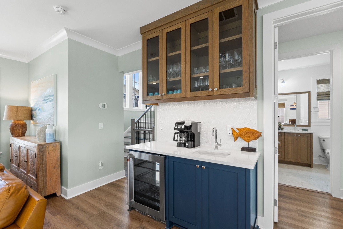 Your personal coffee and beverage station awaits, tucked beneath elegant glass-front cabinetry—perfect for leisurely mornings at home.