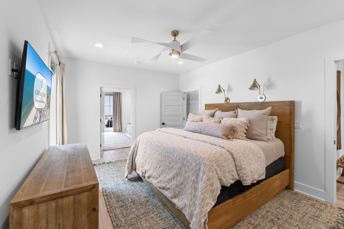Drift off in your serene bedroom featuring a plush king bed, warm wood accents, and coastal-inspired decor that creates the perfect retreat.