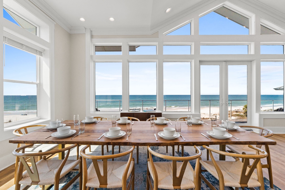 Savor meals with stunning ocean views from your spacious dining area, where floor-to-ceiling windows frame the endless coastline.