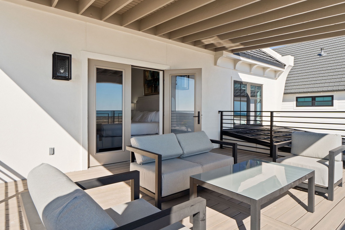 Relax on your private terrace with ocean views and comfortable seating, perfect for morning coffee or sunset cocktails.