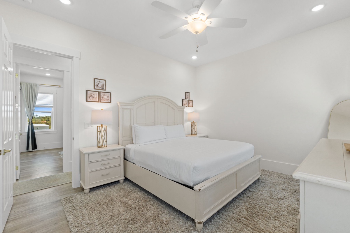 Drift off peacefully in this serene bedroom with plush bedding, soft lighting, and elegant white furnishings that create your perfect retreat.