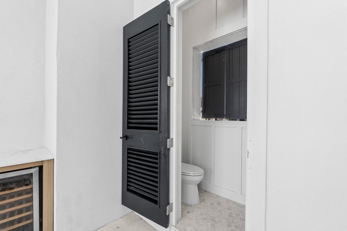 A discreet, modern bathroom accessible from your living space, designed with clean lines and coastal-inspired finishes for your comfort.