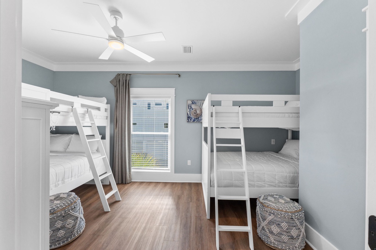 Your spacious bunk room sleeps the whole crew with crisp white beds, soft gray tones, and plenty of natural light. Everyone has their own cozy spot here.