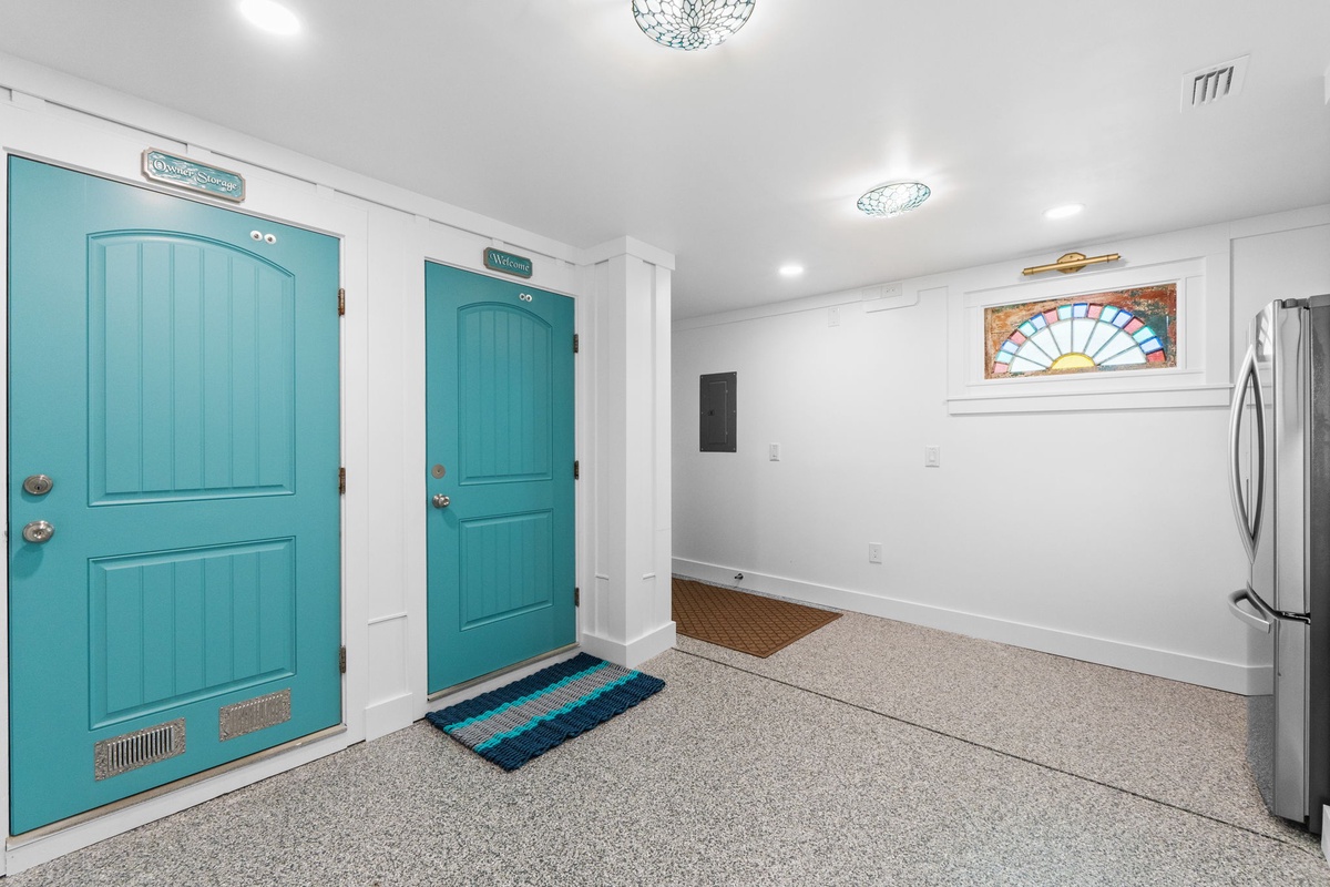 Step into your bright, welcoming space with cheerful turquoise doors and modern appliances ready for your comfortable stay.