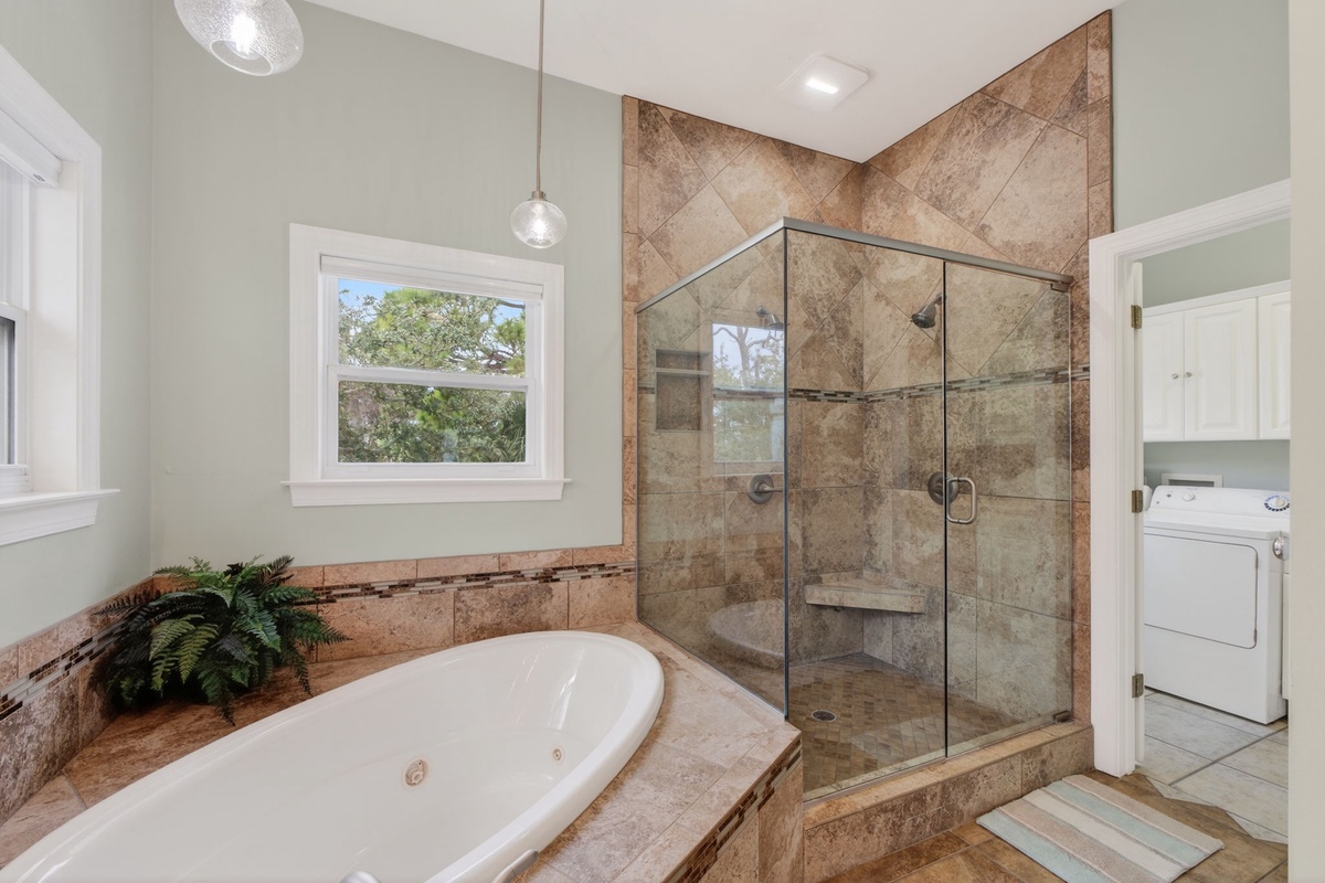 Unwind in your spa-like bathroom with a deep soaking tub and spacious glass shower, perfectly designed for relaxation.