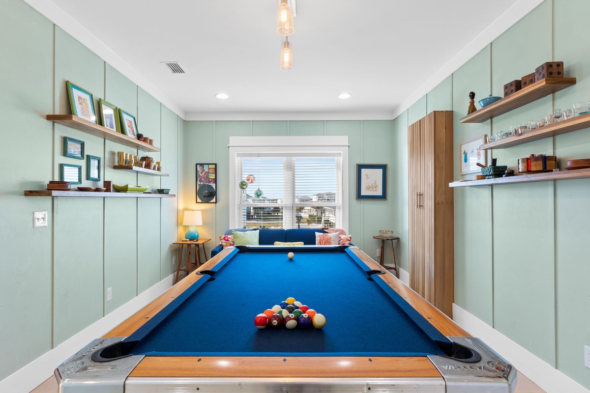 Challenge friends to a game in your stylish entertainment room, featuring a full-size pool table and cozy seating area.