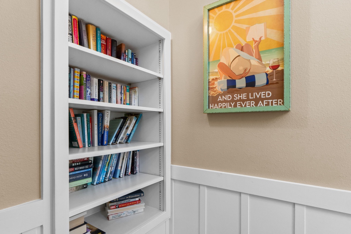 Curl up with a good book from your well-stocked library nook, where countless stories await your next cozy reading session.