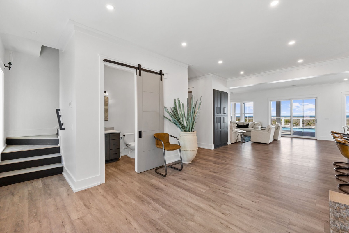 You'll love the open-concept living space with gleaming hardwood floors and stunning water views through floor-to-ceiling windows.