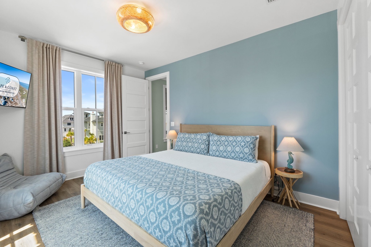 Unwind in your serene coastal-inspired bedroom, where calming blue tones and natural light create a peaceful retreat for restful nights.