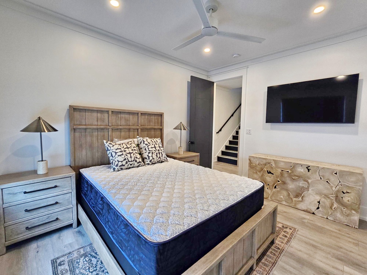 Your stylish bedroom features a plush king bed with rustic wood headboard, creating the perfect retreat for restful nights.