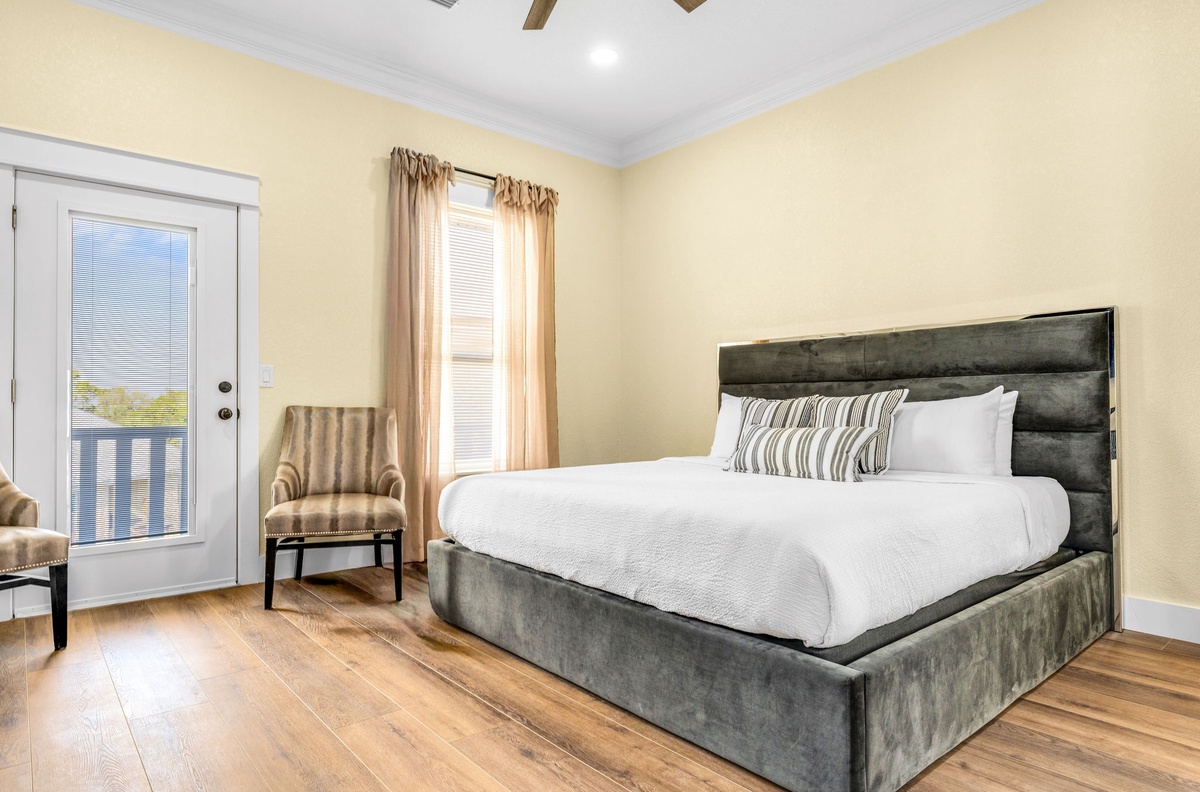 Sink into this plush velvet bed with crisp linens after a day exploring. Your private balcony and cozy seating area create the perfect retreat.