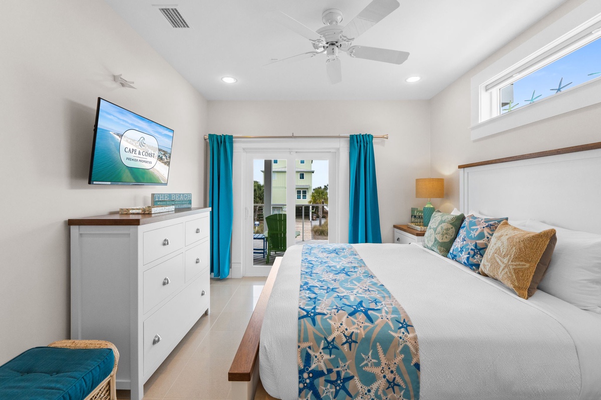 Drift off in coastal comfort with ocean-themed bedding, gentle ceiling fan breezes, and your private balcony just steps away.