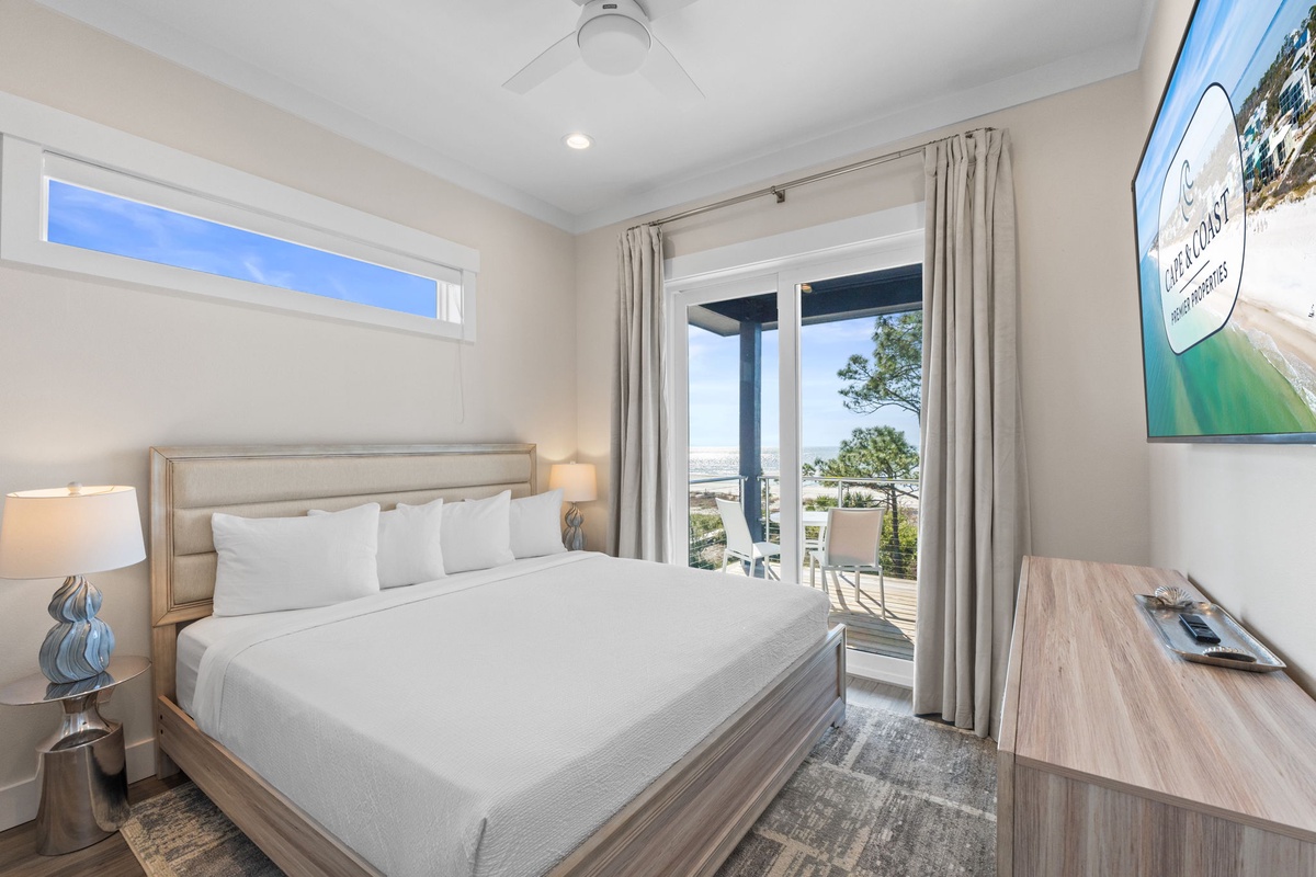 Your bright, airy bedroom features crisp white linens and opens onto your private balcony with serene views.