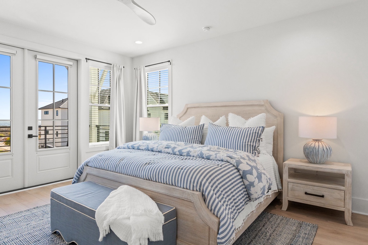 Drift into peaceful sleep in this serene coastal bedroom, where soft blue stripes and ocean breezes create your perfect retreat.