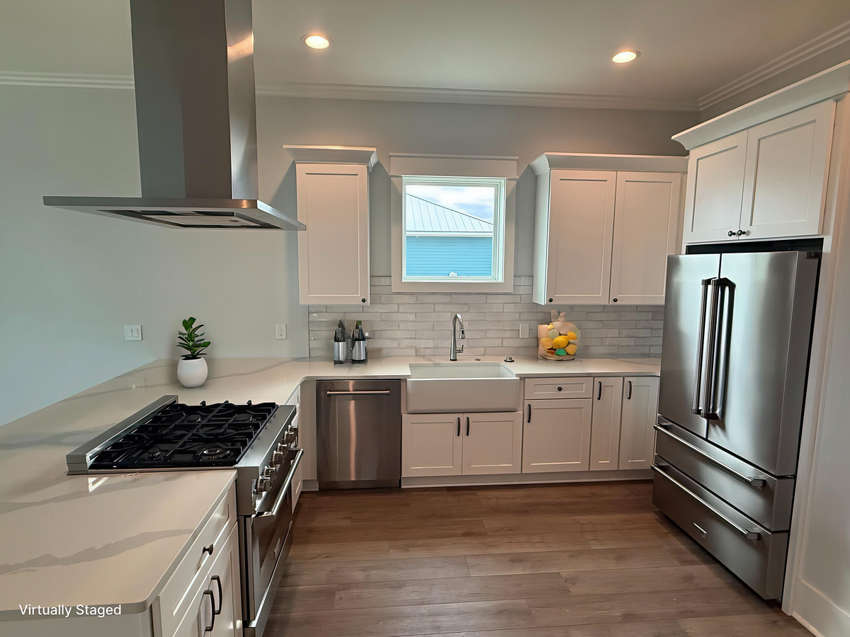 Your modern kitchen features sleek white cabinets, stainless steel appliances, and a spacious farmhouse sink perfect for preparing meals.