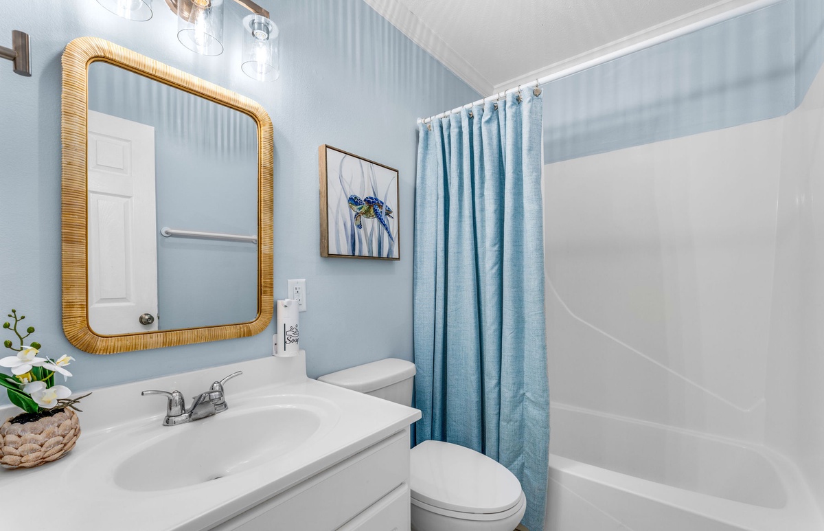 Refresh in your bright, coastal-inspired bathroom with modern fixtures, a relaxing tub, and cheerful blue accents that make your morning routine feel like a spa retreat.