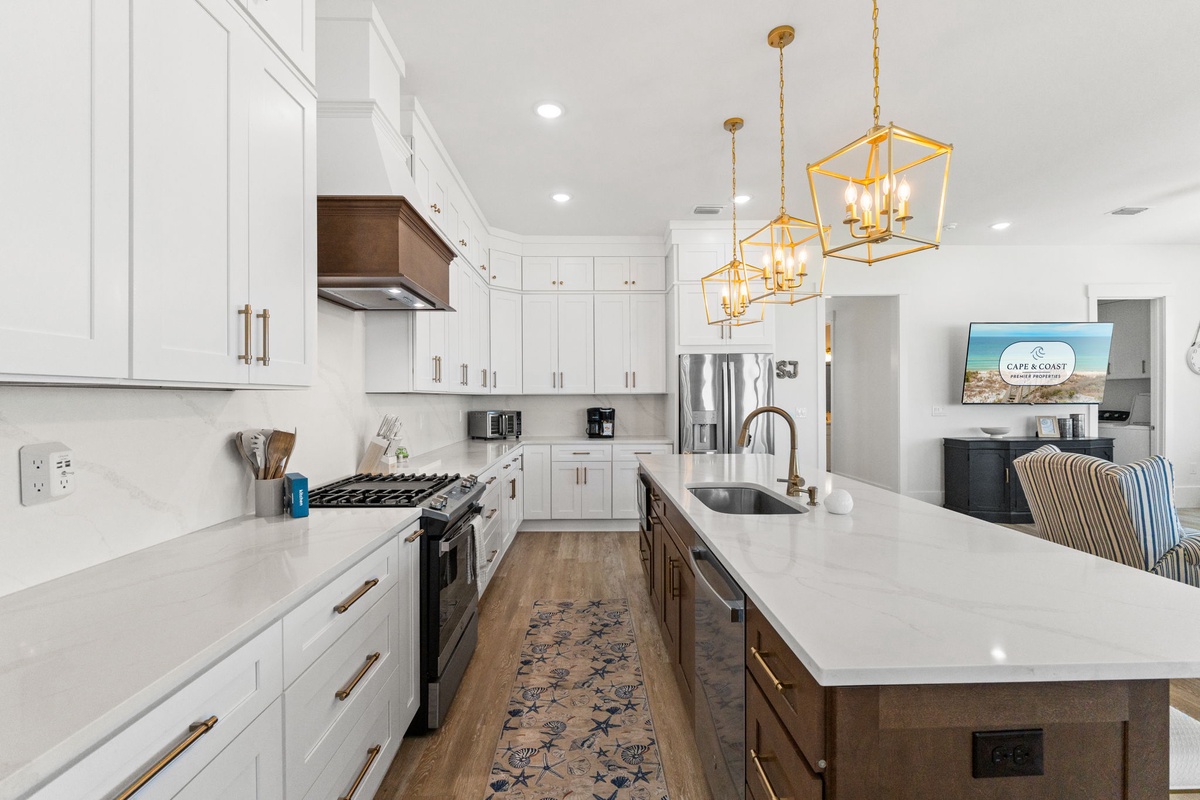 Your gourmet kitchen invites culinary adventures with gleaming quartz countertops, professional appliances, and warm pendant lighting creating the perfect cooking sanctuary.