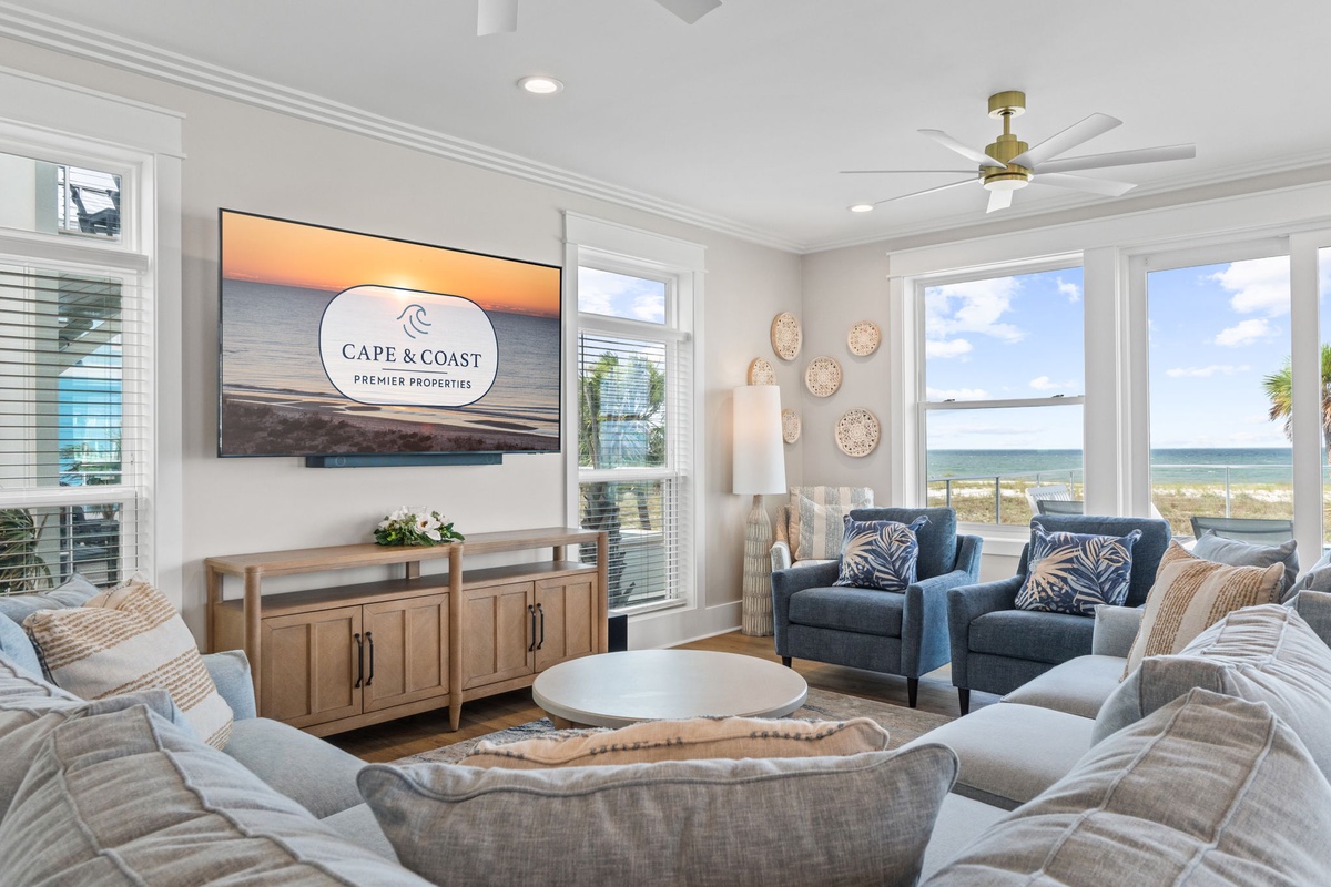 Settle into coastal comfort where plush seating and ocean breezes meet. Large windows frame stunning beach views, inviting the outdoors in while you relax in style.