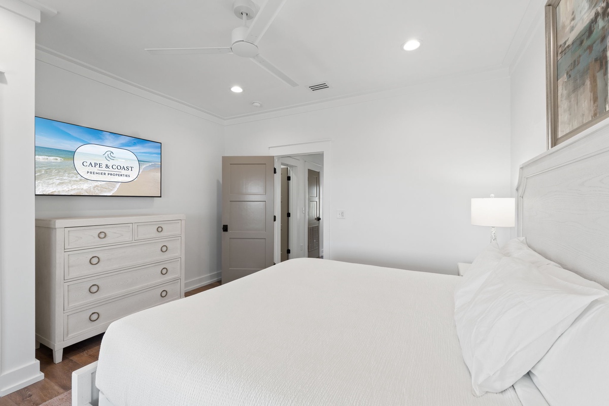 Drift into peaceful sleep in this serene bedroom with plush bedding and coastal charm.