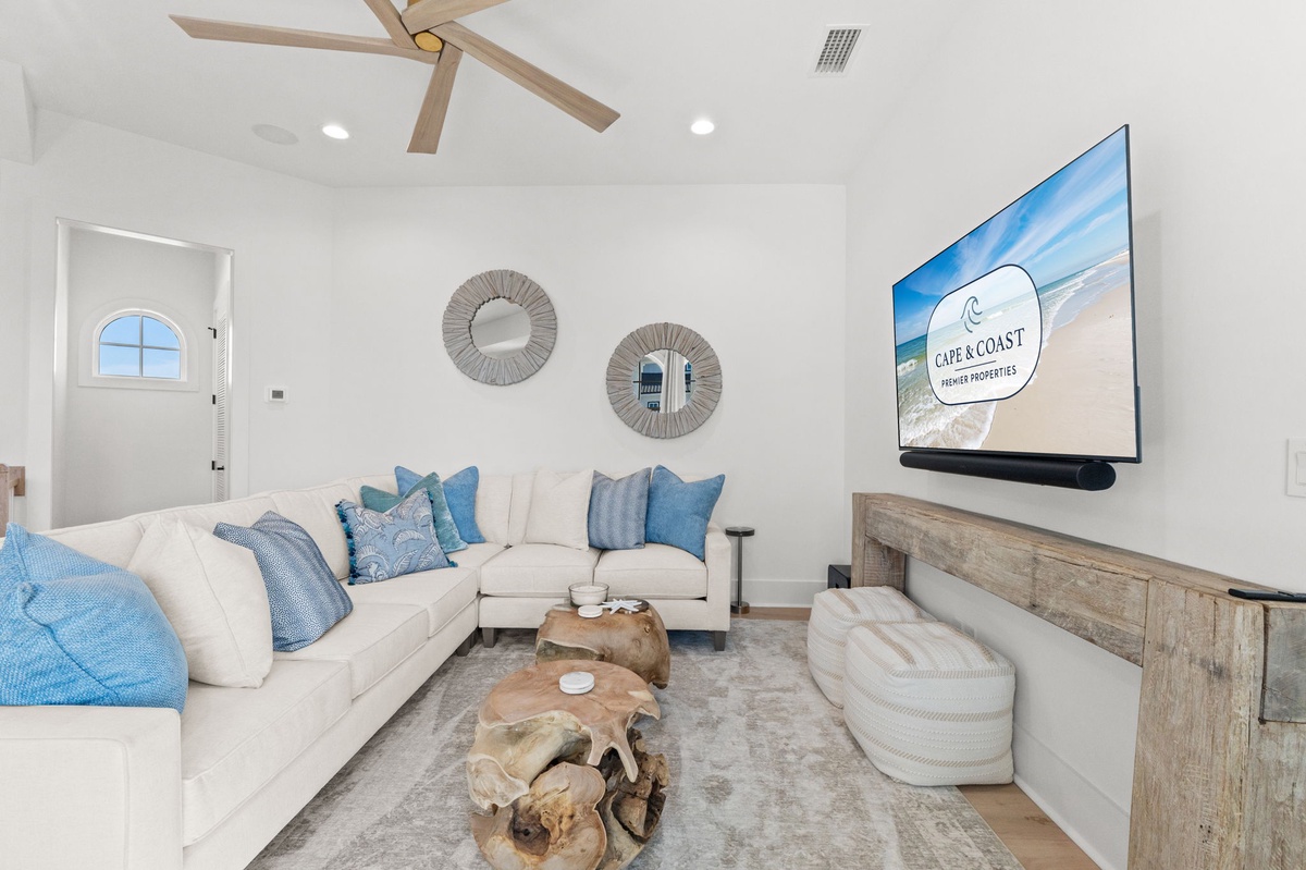Unwind in your bright living room where coastal blues meet comfort—plush sectional seating and ocean-inspired decor create your perfect relaxation sanctuary.