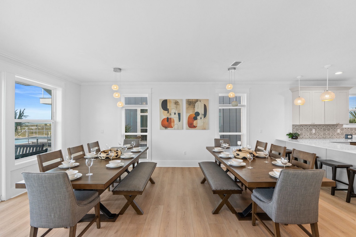 Gather around spacious tables set for memorable meals, with coastal views and modern art creating a warm, inviting atmosphere for your group.