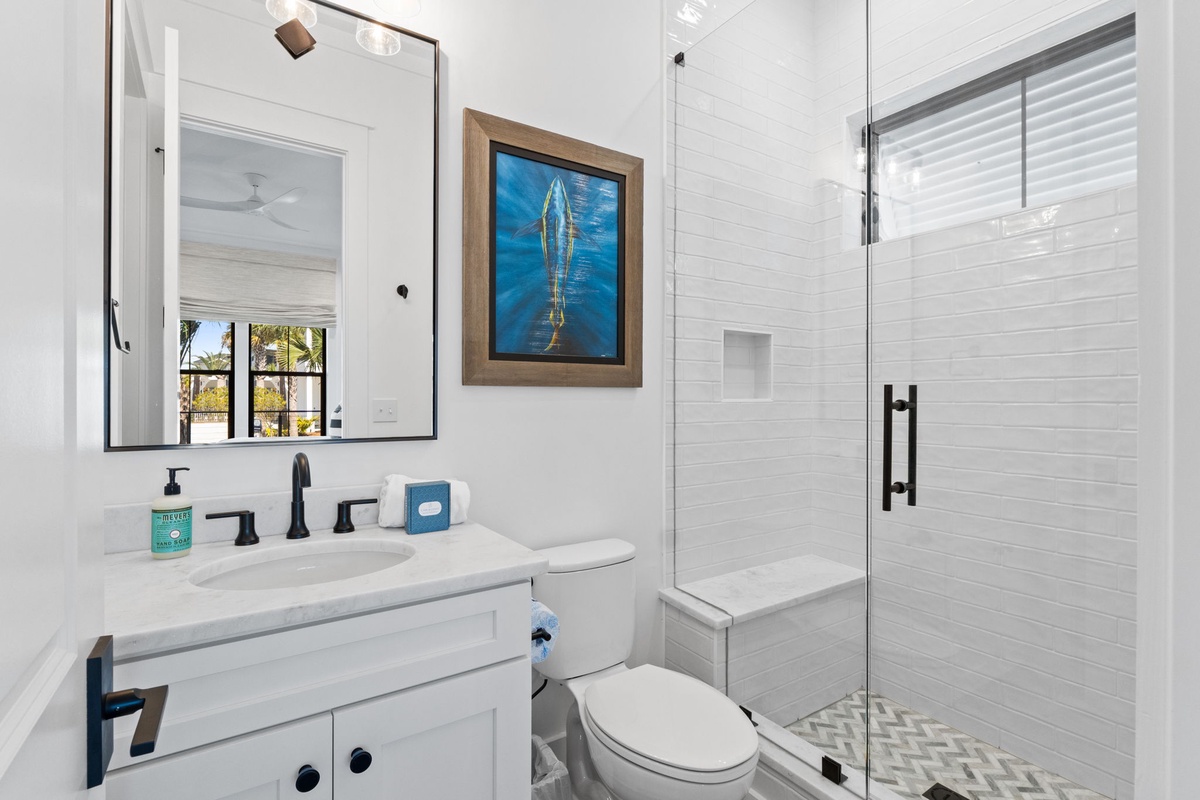 Refresh in your beautifully appointed bathroom with elegant white subway tiles, a spacious walk-in shower, and modern amenities for ultimate comfort.