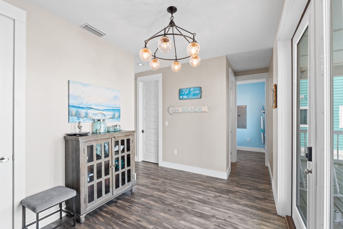 Step into your welcoming coastal retreat where beach-themed décor and warm lighting create the perfect vacation atmosphere.
