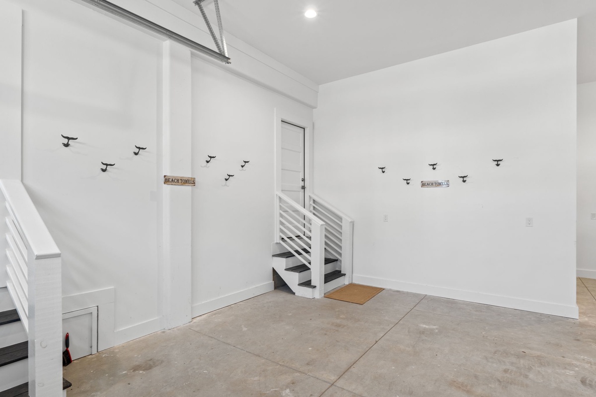 A bright, coastal-inspired entryway welcomes you with cheerful shorebird wall accents and a beach-themed doormat, setting a relaxed, seaside tone for your stay.