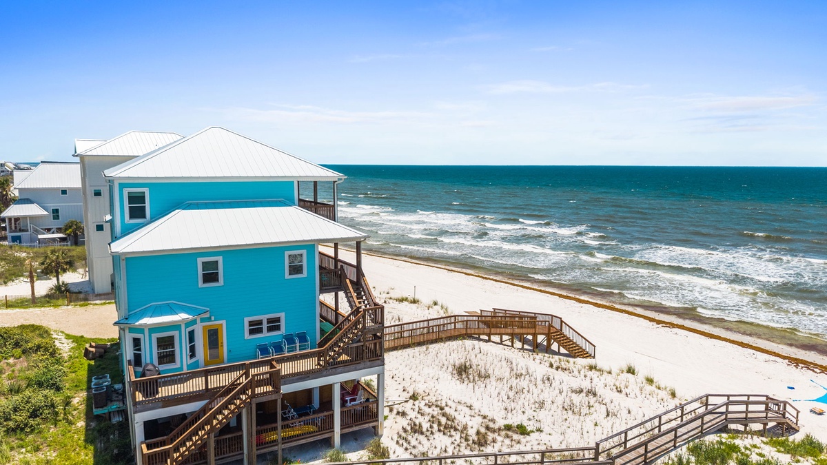 Bright beachfront property featuring direct access to pristine shoreline and sweeping ocean views, located in a peaceful coastal setting.
