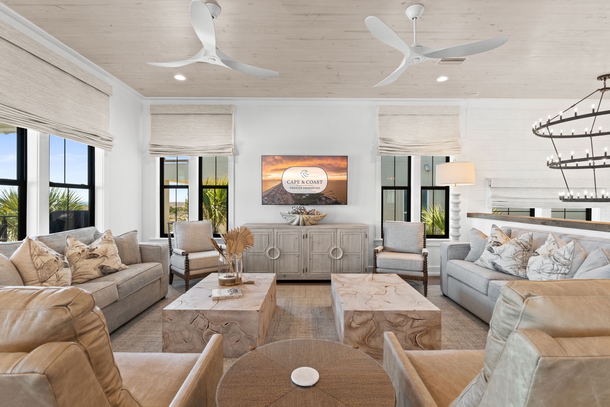 Unwind in your spacious living room with plush seating, natural textures, and coastal-inspired décor creating the perfect retreat atmosphere.