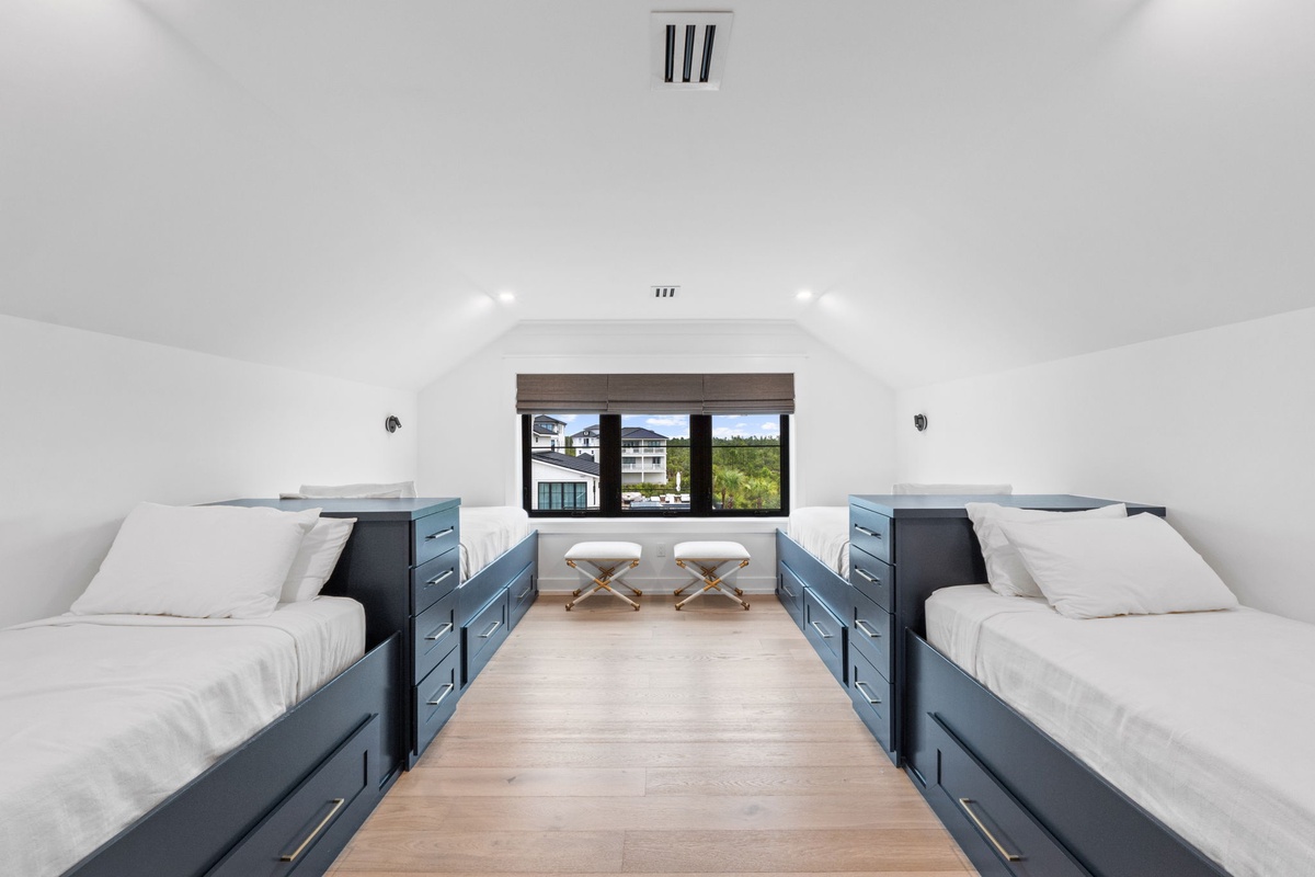 Your loft bedroom features two spacious beds with built-in storage, offering a bright, airy retreat with natural light and mountain views to wake up to each morning.
