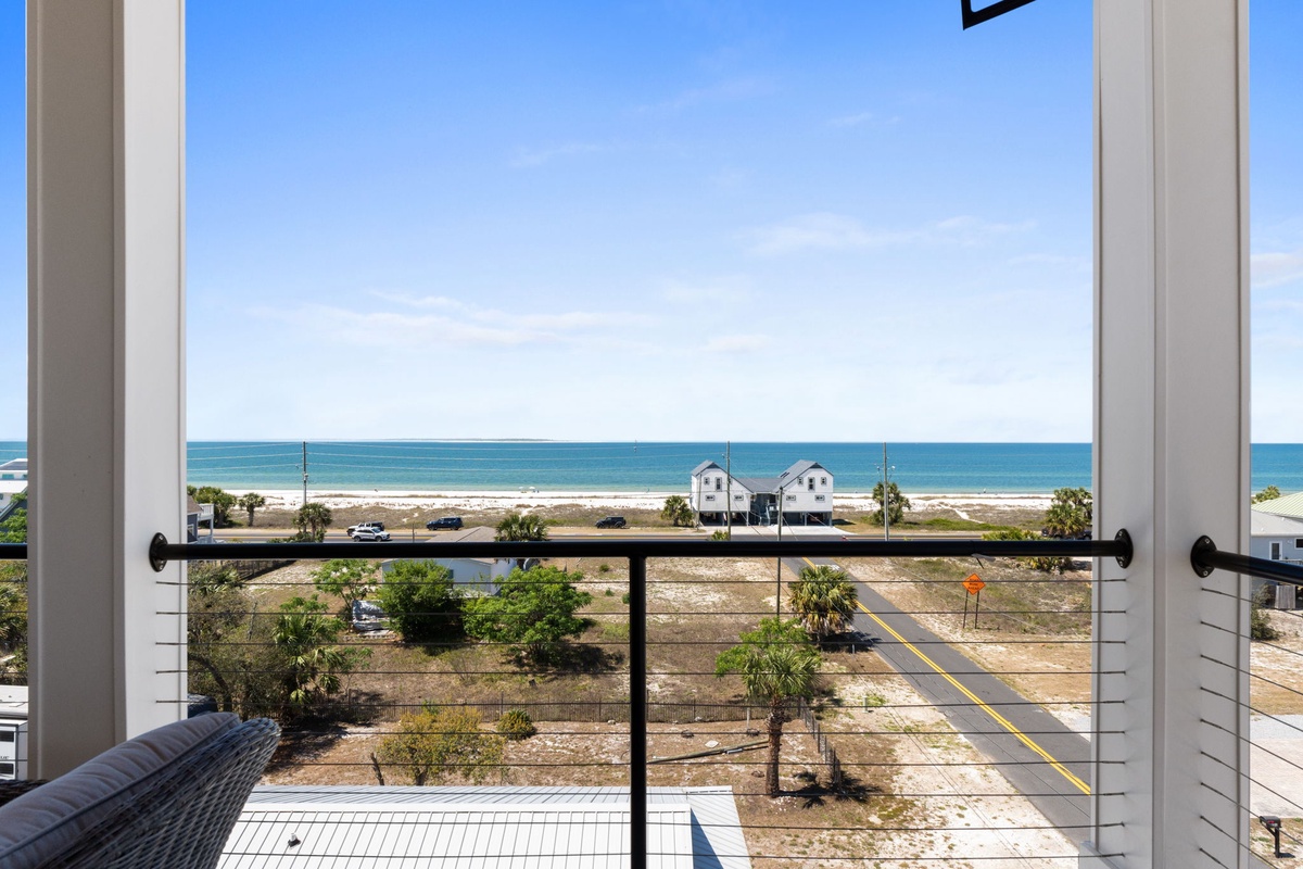 Stunning ocean views stretch endlessly from your private balcony, where turquoise waters meet pristine sandy shores just steps away.